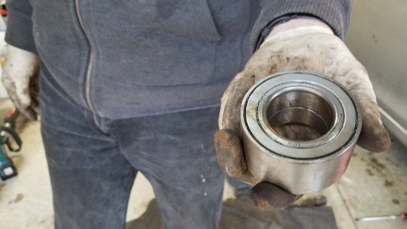 Mobile mechanic about to install new wheel bearing.